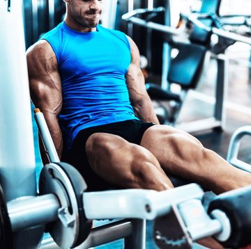 Young man exercising legs in the local gym