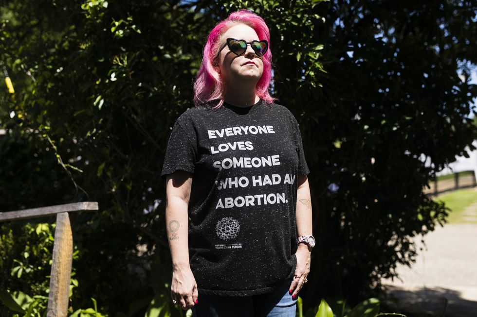 mia raven wearing a shirt that reads everyone loves someone who had an abortion