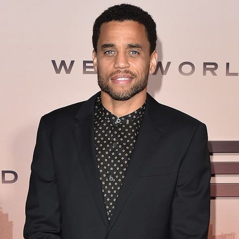 michael ealy attends a press event in march 2020, posing for the camera and wearing a black suit