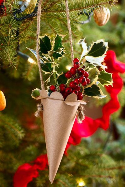 cone ornament with berries and leaves in it