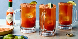 michelada in a glass with a tajin rim and lime garnish