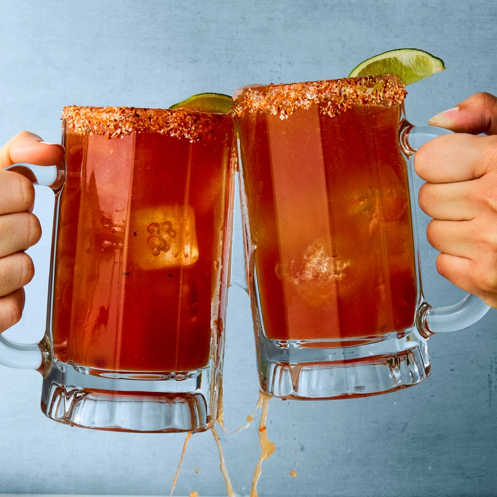 michelada in a glass with a tajin rim and lime garnish