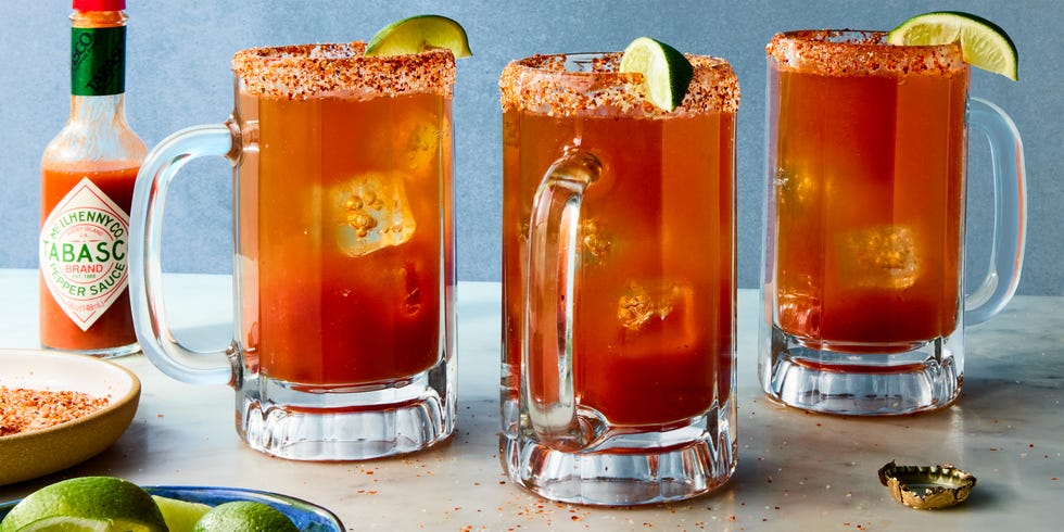 michelada in a glass with a tajin rim and lime garnish