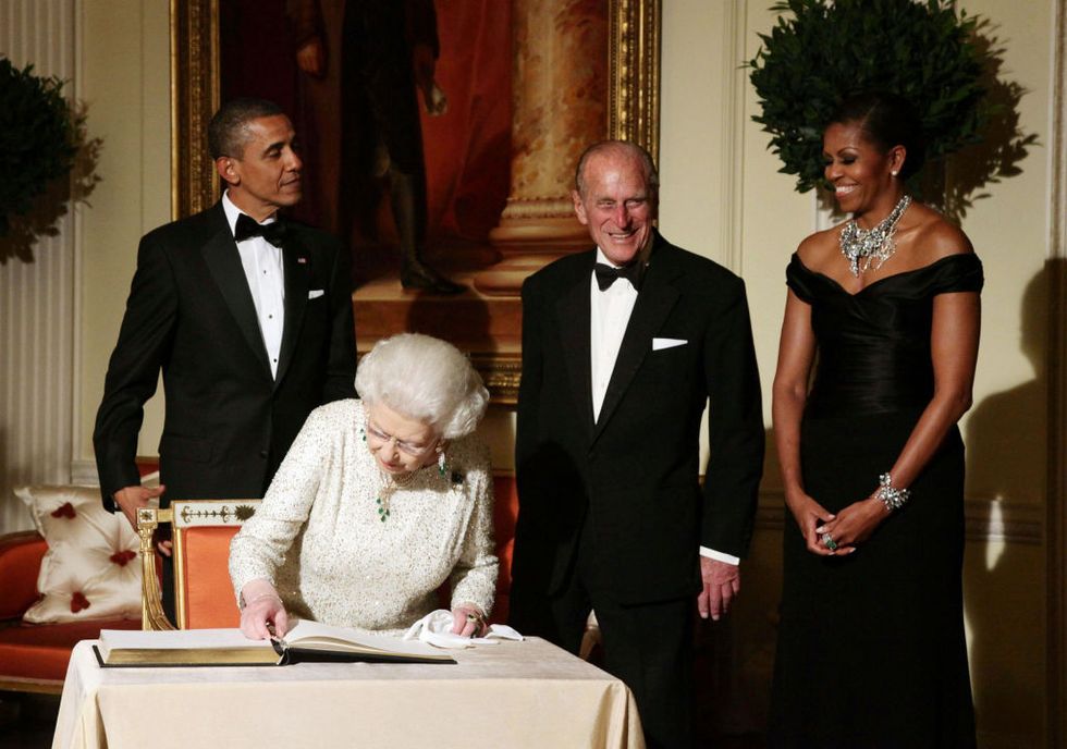 queen elizabeth ii signs the guest book as she bids farewell to us president barack obama and first lady michelle obama, watch by the duke of edinburgh at winfield house   the residence of the ambassador of the united states of america   in regents park, london   photo by yui mokpa images via getty images
