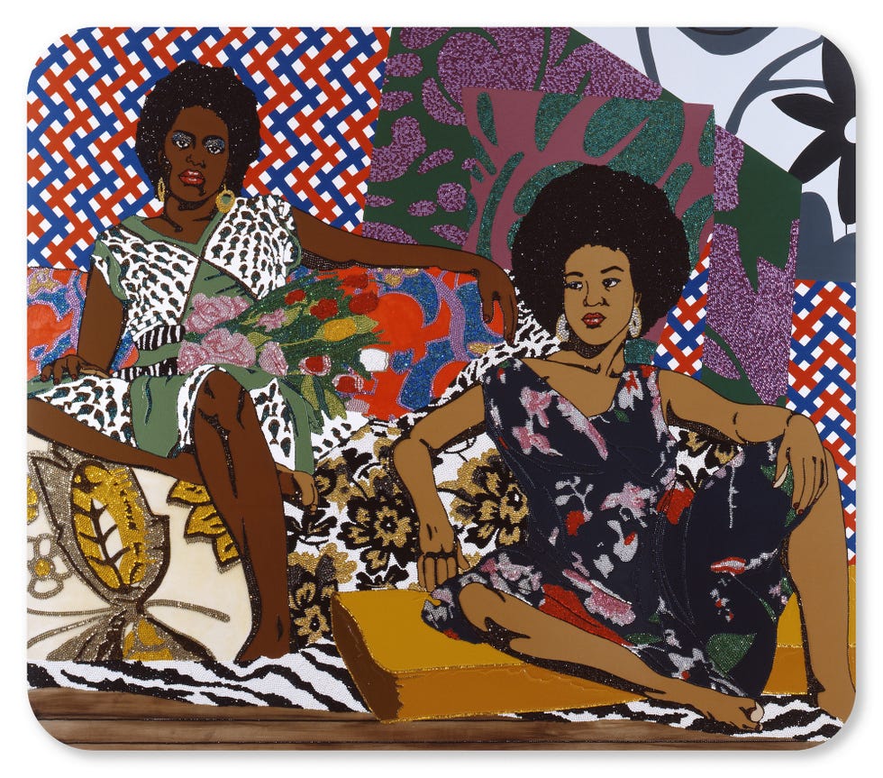 two women sitting on a vibrant patterned surface showcasing diverse clothing styles