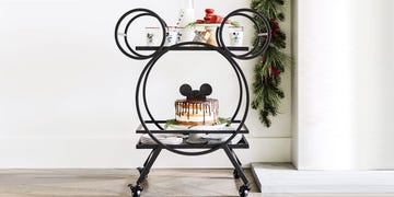 mickey mouse kitchen cart with a mickey mouse cake and plate and glasses