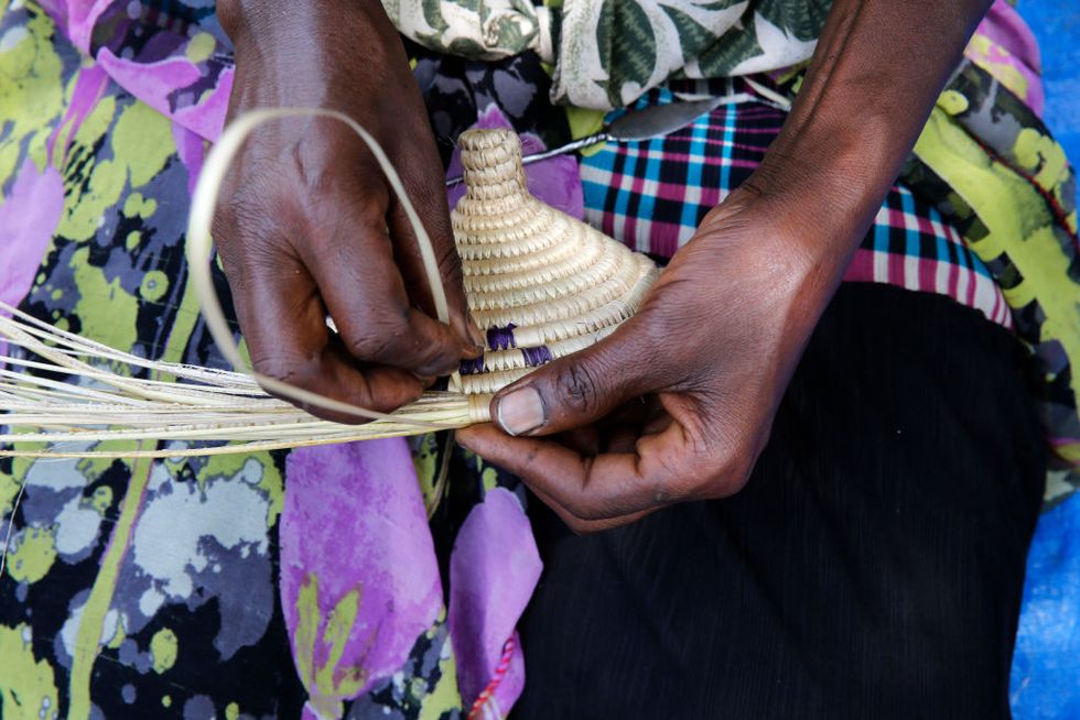 ENCOT microfinance client making a rattan basket.
