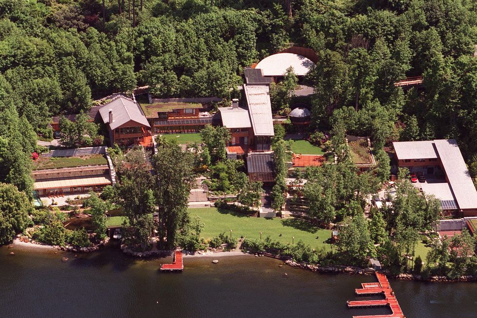 aerial view of a property with several buildings on the shore of a body of water