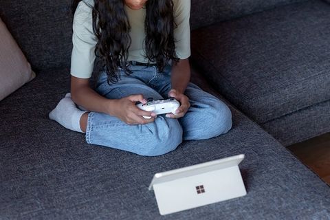 girl gaming with microsoft surface go 3