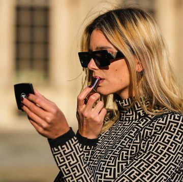 paris, france   november 12 natalia verza wears black sunglasses, gold earrings, a beige with black monogram turtleneck  long sleeves t shirt from balmain, during a street style fashion photo session, on november 12, 2021 in paris, france photo by edward berthelotgetty images