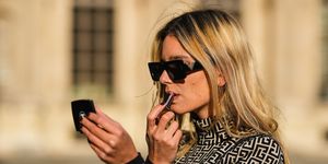 paris, france   november 12 natalia verza wears black sunglasses, gold earrings, a beige with black monogram turtleneck  long sleeves t shirt from balmain, during a street style fashion photo session, on november 12, 2021 in paris, france photo by edward berthelotgetty images