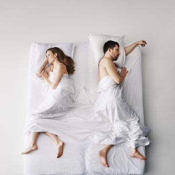 mid adult couple sleeping in bed, elevated view