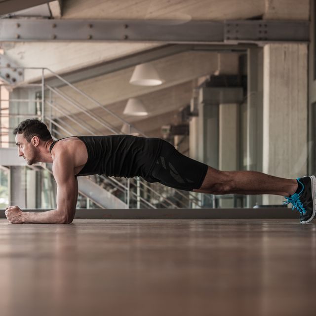 Mid adult man doing plank exercise