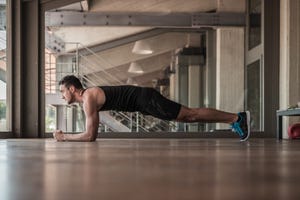 Mid adult man doing plank exercise