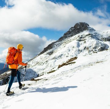 mid adult man hiking in winter mountain alone