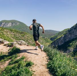 mid adult man running on the hill and mountain ridge