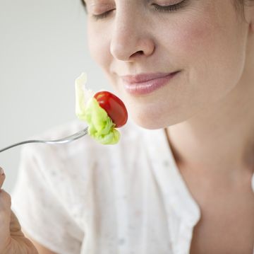 mid adult woman enjoying fresh vegetables