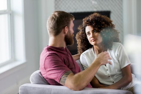 the mid adult woman listens carefully and seriously to her unrecognizable husband as he shares his ideas about their new home