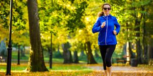 mid adult woman running in city park
