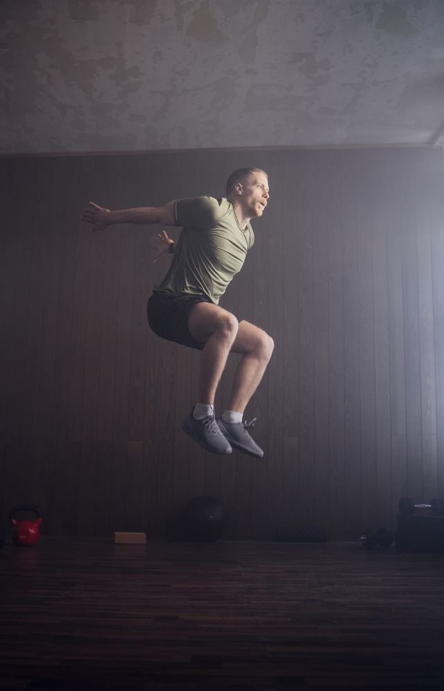 mid air photo of a professional sportsman training indoors