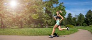 middle aged slim caucasian woman sportswear running,jogging training in park in sunny day summer,russia