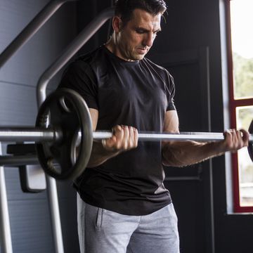 middle aged strong bodybuilder athlete working biceps