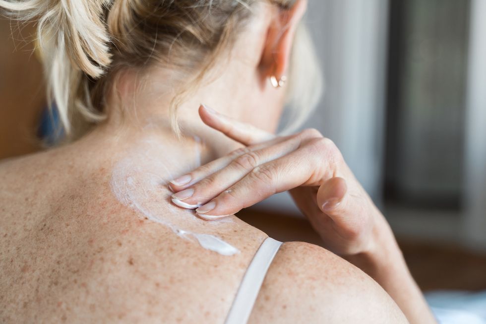 middle aged woman using hormone gel on her skin, hormone replacement therapy