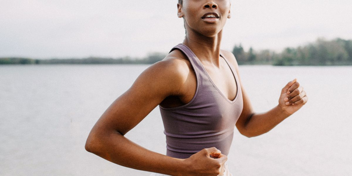 https://hips.hearstapps.com/hmg-prod/images/midsection-of-a-woman-jogging-by-a-tranquil-body-of-royalty-free-image-1752853665.pjpeg?crop=1xw:0.75147xh;center,top&resize=1200:*