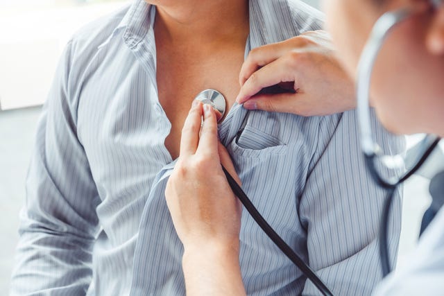 midsection of doctor examining patient in hospital