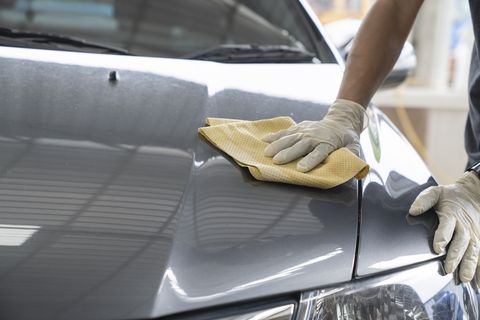 midsection of man cleaning car