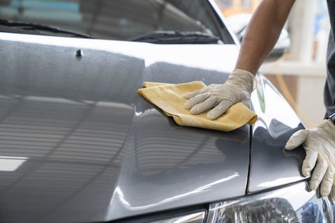 midsection of man cleaning car