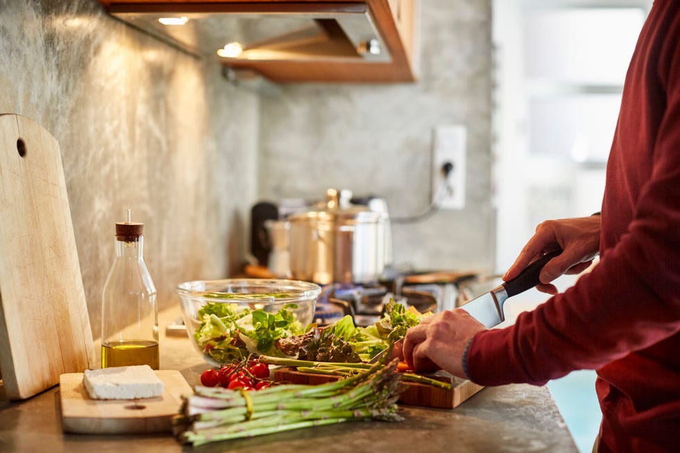 midsection of man cutting vegetables