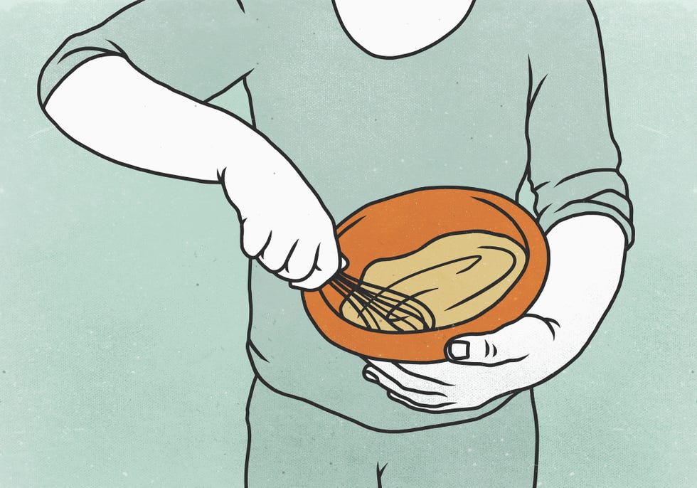 Midsection of man mixing batter in bowl against colored background