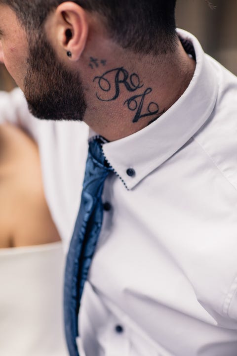 midsection of man with tattoo on neck