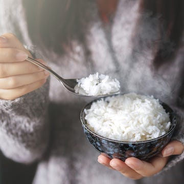 midsection of woman holding rice in bowl