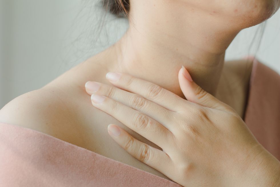 midsection of woman massaging neck
