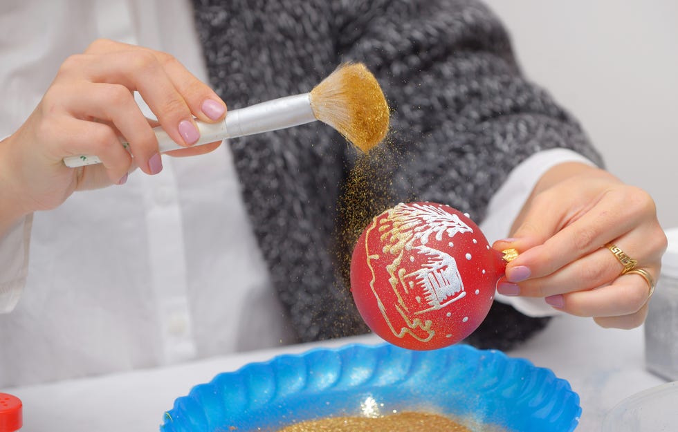 midsection of woman preparing bauble