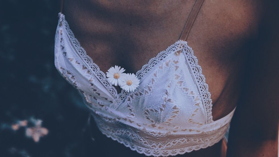 midsection of woman wearing white bra with flowers