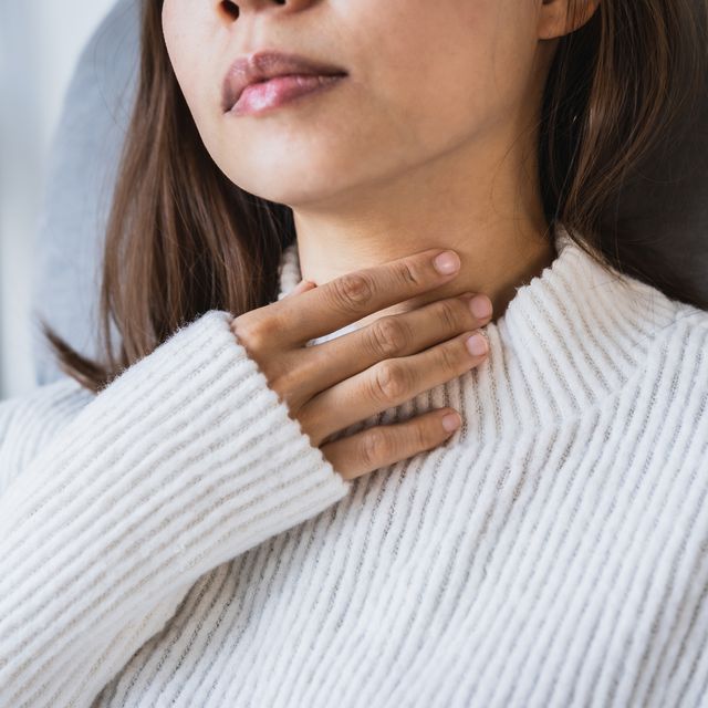 midsection of woman wearing white sweater