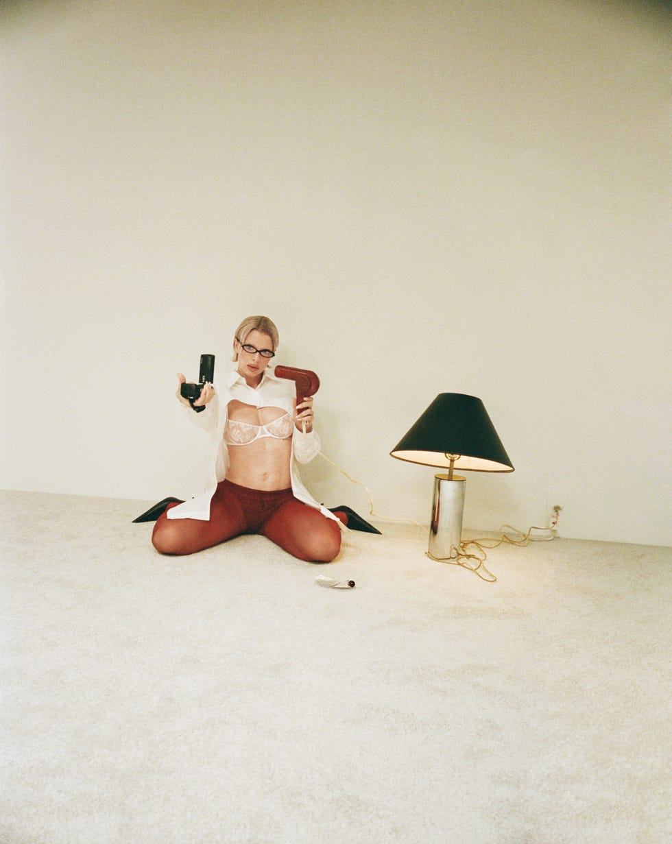 a person displaying a provocative pose in a minimalist setting