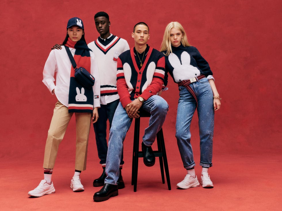 group of four individuals posing in stylish casual miffy clothing against a red background