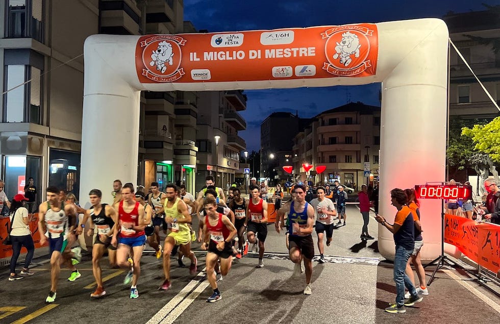 start of a running event with participants launching from the starting line
