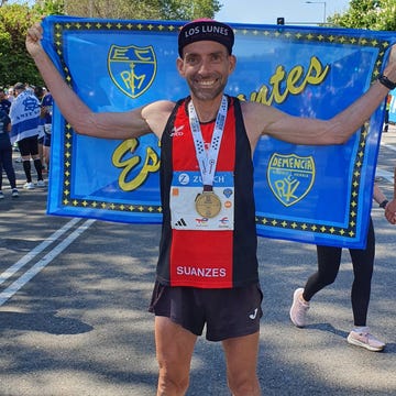 runner celebrating with a medal and flag after a race runner celebrating with a medal and flag after a race