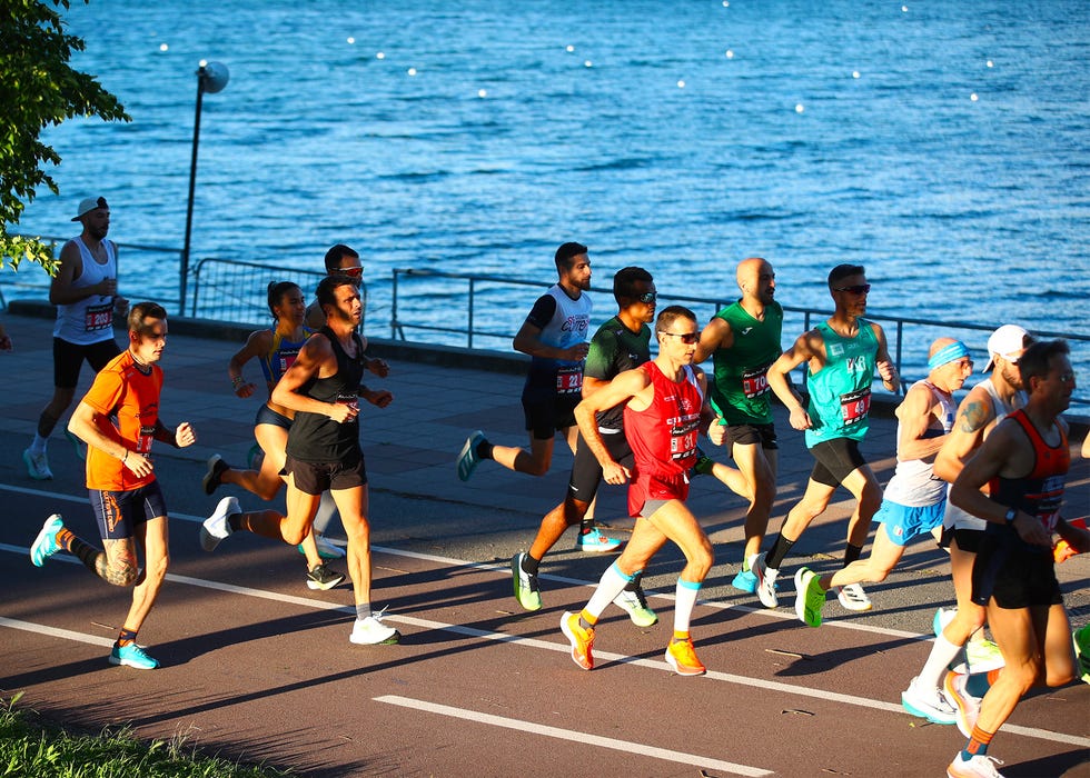 runners participating in an active running event along a waterfront