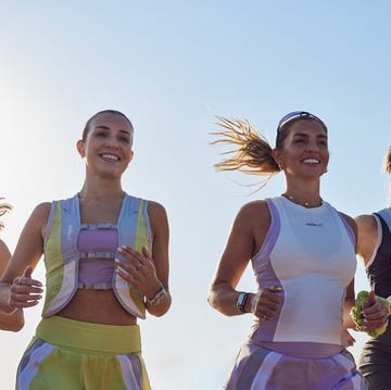 a group of women running and smiling a group of women running and smiling