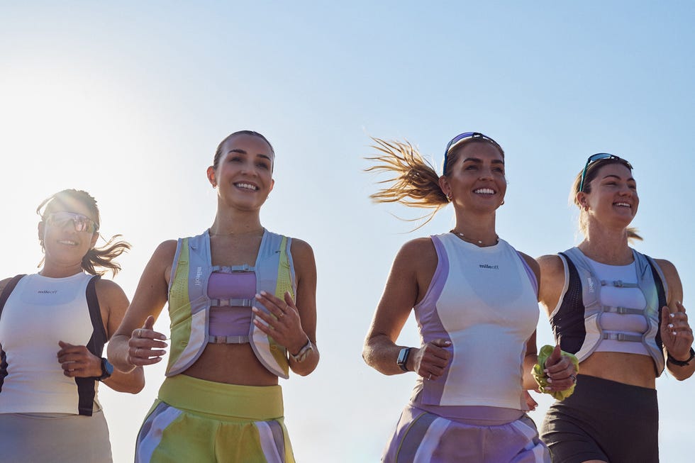 a group of women running and smiling