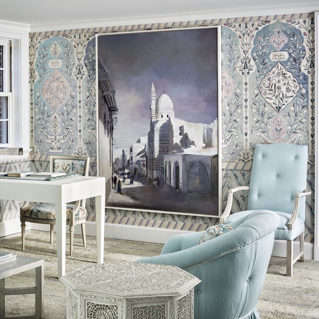 a blue and white room with mosaic tile looking wallpaper and an overscale photo on the wall