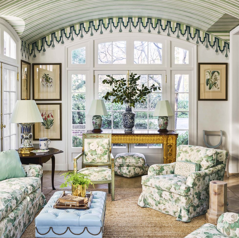 a striped and curved ceiling and seagrass carpet and floral upholstered furniture