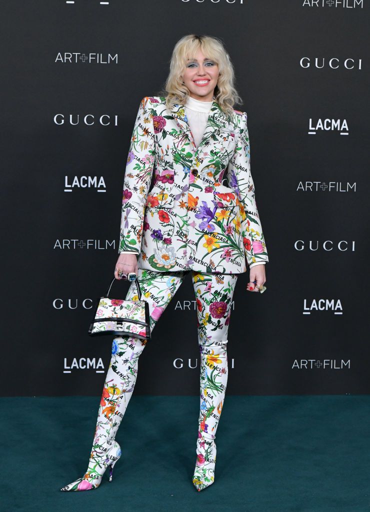 Who made Miley Cyrus' green coat, black sequin dress, patent sandals, and  silver handbag? – OutfitID