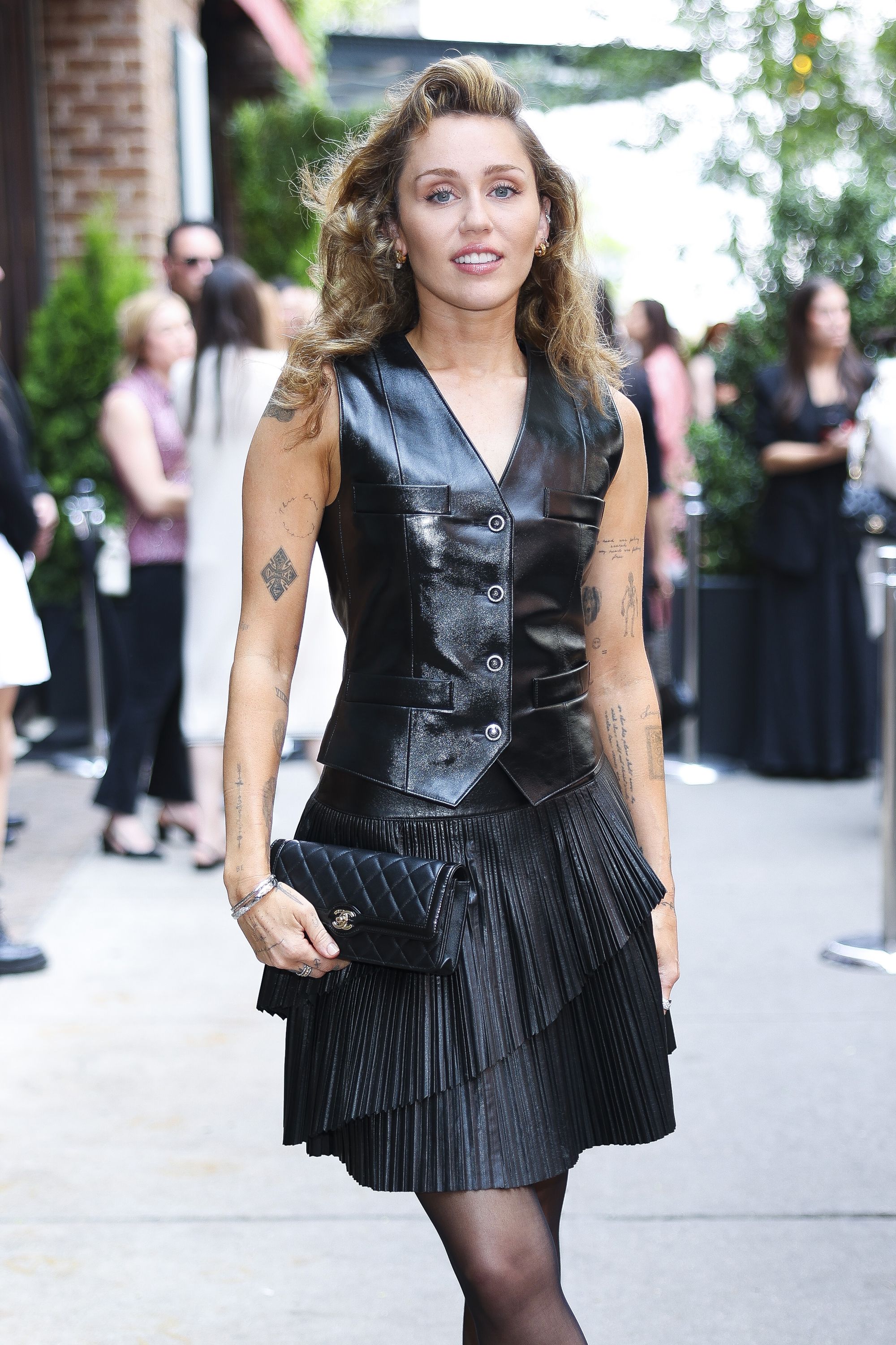 Miley Cyrus Channels Soft Rock in Leather Pleated Skirt and Mary Jane Heels